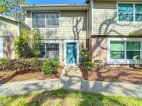 Charming condo featuring a well-maintained front exterior with neat landscaping and a freshly painted door at 14611 Pine Glen Cir, Lutz, FL 33559