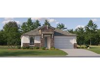 Charming single-Gathering home featuring stone accents, a well-manicured lawn, and an attached two-car garage at 18473 Serene Lake Loop, Lutz, FL 33548