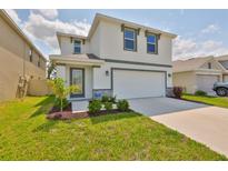 Charming two-story home with a well-manicured lawn and inviting entrance at 2858 Star Anise Ln, Wimauma, FL 33598