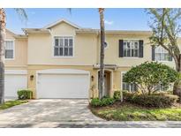 Charming townhome with a two-car garage, manicured landscaping, and a welcoming entrance at 3429 Heards Ferry Dr, Tampa, FL 33618