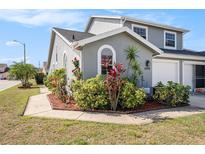 Charming two-story home featuring lush landscaping, well-maintained lawn, and a welcoming exterior at 4270 Boston Cir, New Port Richey, FL 34653