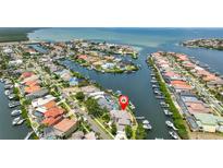 Stunning aerial view of waterfront property with boat docks and Gulf access in a beautiful coastal community at 915 Symphony Isles Blvd, Apollo Beach, FL 33572