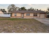 Charming single story home with a cozy, well-lit exterior, neat lawn, and inviting curb appeal at 12230 Skyler Ln, Spring Hill, FL 34609