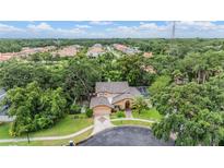Stunning home with a sprawling lawn, mature trees, pool, and an attached two-car garage at 3013 Crest Dr, Clearwater, FL 33759