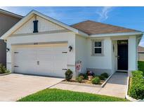 Charming single-Gathering home with a two-car garage, landscaped front yard, and welcoming entrance at 32714 Brooks Hawk Ln, Wesley Chapel, FL 33543