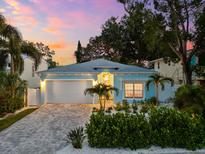 Charming single story home with nicely landscaped yard and brick driveway under a colorful sunset sky at 475 Crystal Beach, Crystal Beach, FL 34681