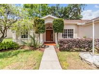Inviting front entrance with a well-manicured lawn and beautiful landscaping, creating excellent curb appeal at 4915 Fort Peck Rd, New Port Richey, FL 34655