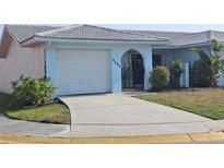 Quaint one-story home featuring an attached single car garage and wrought iron gated courtyard at 5404 Springwood Blvd # 5404, Pinellas Park, FL 33782