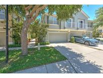 Charming townhome featuring an attached garage, balcony, and well-maintained landscaping in a desirable community at 6782 Breezy Palm Dr, Riverview, FL 33578