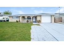 Charming home with a well-manicured lawn and inviting curb appeal at 7405 Oakshire Dr, Port Richey, FL 34668