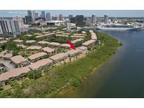 Stunning aerial view of waterfront condo community, showcasing lush landscaping and bay views in a vibrant city setting at 1111 Normandy Trace Rd # 1111, Tampa, FL 33602