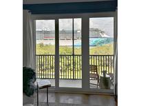Balcony view showcasing a cruise ship, greenery, and glimpses of the outdoor scenery enhancing the living experience at 1111 Normandy Trace Rd # 1111, Tampa, FL 33602