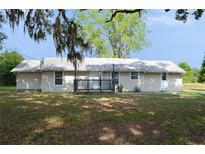 Charming single-story home featuring a metal roof and front porch at 11141 Rex Hunter Ln, Lithia, FL 33547