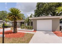 Charming single-story home features a well-manicured lawn, updated landscaping, and a one-car garage at 2012 Scotland Dr, Clearwater, FL 33763