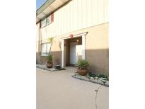 Inviting condo entrance features potted plants and a well-lit doorway at 300 6Th N St # E3, Safety Harbor, FL 34695