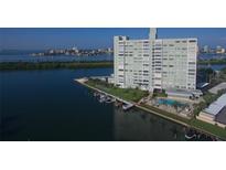 Waterfront condominium building with boat slips, a pool, and stunning views of the bay and surrounding area at 31 Island Way # 1403, Clearwater Beach, FL 33767