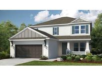 Charming two-story home featuring a landscaped yard, two-car garage, and inviting front porch at 33626 Castaway Loop, Wesley Chapel, FL 33543