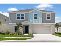 Charming two-story home with a well-manicured lawn, two car garage, and inviting curb appeal at 36971 Sagemoor Dr, Zephyrhills, FL 33541