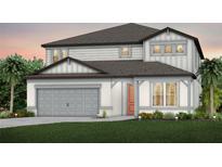 Charming two-story home with a gray garage, siding and an inviting front door at 3765 Obsidian Dr, Spring Hill, FL 34609