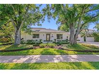 Charming single-story home with well-manicured landscaping and mature shade trees at 444 W Davis Blvd, Tampa, FL 33606