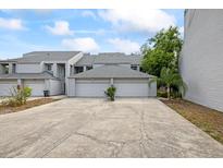 Charming townhouse featuring a multi-car driveway and two-car garage at 9722 Tiffany Oaks Ln, Tampa, FL 33612