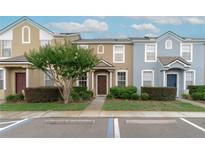 Charming townhomes featuring colorful facades, landscaped grounds, and convenient parking at 1250 Charlesworth Dr, Wesley Chapel, FL 33543