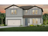 Charming two-story home featuring gray siding, a two-car garage, and beautifully landscaped front yard at 3860 Obsidian Dr, Spring Hill, FL 34609