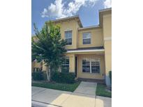 Two-story townhome with neutral exterior, well-maintained landscaping, and sunny curb appeal at 6250 Maisie Rd, Zephyrhills, FL 33542