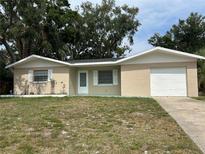 Charming single-story home with a well-maintained lawn and attached garage, presenting an inviting curb appeal at 2075 Plateau Rd, Clearwater, FL 33755