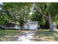 Charming single-story home with a lush, tree-filled yard and an inviting driveway at 3212 56Th N Ave, St Petersburg, FL 33714