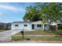Charming single-story home with a well-manicured lawn and mature tree in a sunny neighborhood at 8277 82Nd N Ave, Largo, FL 33777