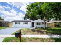 Charming renovated single-story home with new driveway and fresh landscaping and black trim at 8277 82Nd N Ave, Largo, FL 33777