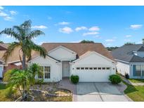 Charming single-story home with a well-manicured lawn and a two-car garage at 11307 Calgary Cir, Tampa, FL 33624