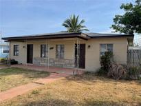 Single-story home featuring a covered porch, neutral paint, and xeriscaping in the front yard at 14067 Marguerite Dr, Madeira Beach, FL 33708