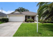 Charming single-story home with a well-manicured lawn and a two-car garage at 1744 Brookstone Way, Plant City, FL 33566
