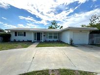Charming single-story home featuring a well-maintained lawn, a concrete driveway, and a one-car garage at 3300 58Th N St, St Petersburg, FL 33710