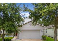 Charming two-story home featuring a two-car garage, well-maintained lawn and mature trees in a Gathering-friendly neighborhood at 396 Winthrop Dr, Spring Hill, FL 34609