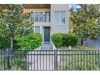 Inviting front entrance with a black metal fence, lush landscaping, and a modern facade at 4911 N Nebraska Ave, Tampa, FL 33603