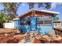 Charming blue bungalow with stone accents, a welcoming front entrance, and lovely landscaping at 520 4Th Nw St, Largo, FL 33770