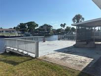 Waterfront backyard with wooden deck, offering serene views at 8422 Boxwood Dr, Tampa, FL 33615