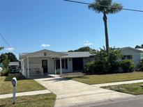 Charming single story home with palm tree, covered entrance, and well manicured front lawn at 8422 Boxwood Dr, Tampa, FL 33615