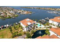 Beautiful waterfront condo with lush landscaping, community pool, and marina access at 1003 Bellasol Way # 9203, Apollo Beach, FL 33572