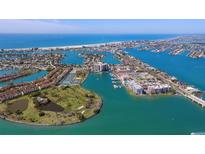 Expansive aerial view showcasing a coastal community with beautiful waterways, beaches, and golf course at 10355 Paradise Blvd # 412, Treasure Island, FL 33706