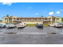 A two-story condo complex with parking, landscaping, and a classic architectural design at 1100 E Bay Dr # 60, Largo, FL 33770