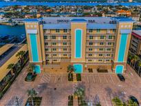 An attractive multi-story condo building with ample parking, waterfront access, and architectural details at 125 Island Way # 502, Clearwater Beach, FL 33767