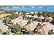 Beautiful aerial view of coastal homes featuring well-manicured lawns and stunning water views at 184 Banyan Bay Dr, St Petersburg, FL 33705