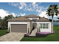 Beautiful single-Gathering home featuring a two-car garage and manicured lawn with garden beds at 32523 Neroli St, Wesley Chapel, FL 33543