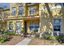 Inviting townhome features a covered porch, well-maintained landscaping, and a freshly painted facade at 3456 Castle Stone Ct, Valrico, FL 33594
