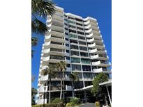Stunning high-rise condo building with private balconies and lush palm trees under a bright blue sky at 80 Rogers St # 6D, Clearwater, FL 33756