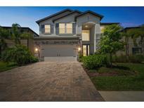 Charming two-story home featuring a brick driveway and well-maintained landscaping at 10945 Sundrift Dr, Tampa, FL 33647
